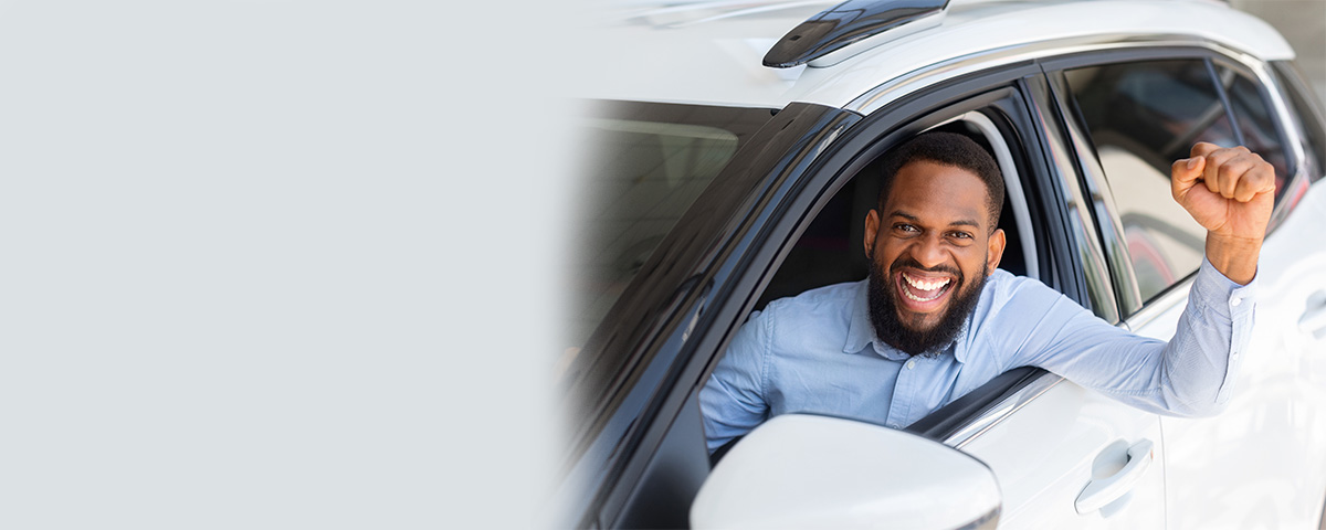 Man celebrating in car